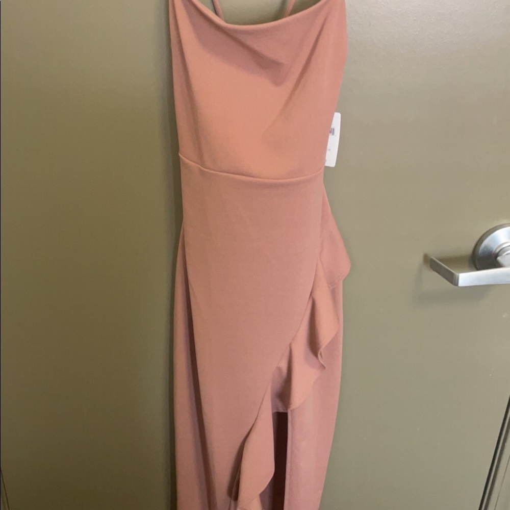 Light pink long dress with slit on side. Straps cross in back. Never worn